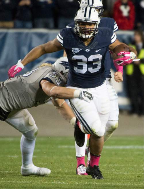 Rick Egan  |  The Salt Lake Tribune

Nevada Wolf Pack defensive end Brock Hekking (53) tries to stop Brigham Young Cougars running back Paul Lasike (33), in football action, BYU vs The Nevada Wolf Pack at Lavell Edwards Stadium, Saturday, October18, 2014