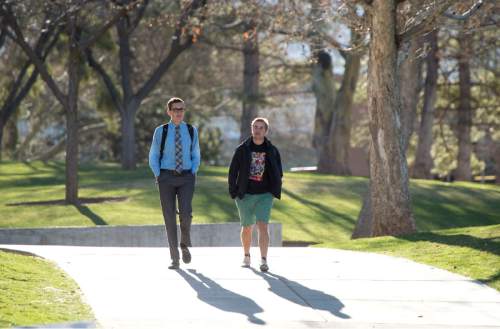 Rick Egan  |  The Salt Lake Tribune
University of Utah students, Ryan Clayton and Sam Babcock walk to class last month. University officials faces student questions on tuition, faculty raises and other issues on Tuesday.