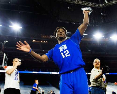 Steve Griffin  |  The Salt Lake Tribune

Duke Blue Devils forward Justise Winslow (12) throws a Duke shirt to the fans following Duke's practice on the NRG Stadium court prior to their 2015 NCAA Men's Basketball Championship Regional Semifinal game against Utah in Houston, Thursday, March 26, 2015. The Houston native is playing before a hometown crowd.