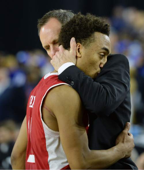 Steve Griffin  |  The Salt Lake Tribune

Utah assistant coach Tommy Connor embraces a dejected Utah Utes guard Brandon Taylor (11) as he fouls out of the game late in the second half action in the University of Utah versus Duke University Sweet 16 game in the 2015 NCAA Menís Basketball Championship Regional Semifinal game at NRG Stadium in Houston, Friday, March 27, 2015.