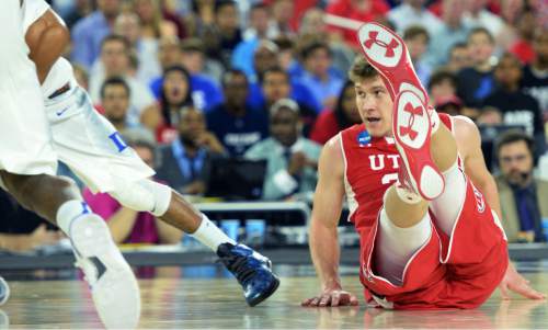 Steve Griffin  |  The Salt Lake Tribune

Utah Utes center Dallin Bachynski (31) falls tot he court as he goes for a loose ball during second half action in the University of Utah versus Duke University Sweet 16 game in the 2015 NCAA Men's Basketball Championship Regional Semifinal game at NRG Stadium in Houston, Friday, March 27, 2015.