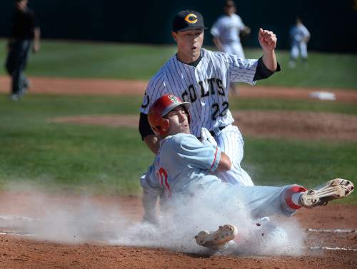 Scott Sommerdorf   |  The Salt Lake Tribune
Cottonwood pitcher Tevita Gerber tags out Jason Money of Spanish Fork at home plate to end the first inning with Spanish Fork ahead 3-0. Cottonwood would storm back and defeat  Spanish Fork 12-5, Friday, March 27, 2015.