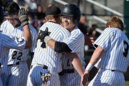 Scott Sommerdorf   |  The Salt Lake Tribune
Cottonwood right fielder Chris Rowan is all smiles as he is greeted by team mates at home plate after he bombed a home run over the left-centerfield fence to give the Colts a 10-5 lead. Cottonwood defeated Spanish Fork 12-5, Friday, March 27, 2015.