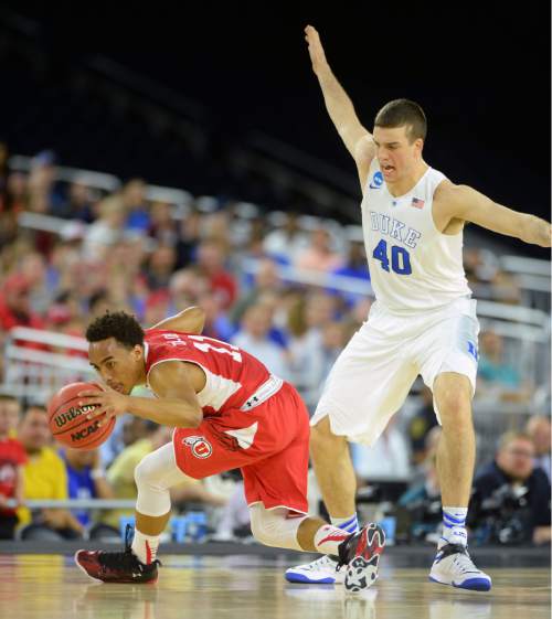Steve Griffin  |  The Salt Lake Tribune

Utah Utes guard Isaiah Wright (1) spins away from Duke Blue Devils center Marshall Plumlee (40) during first half action in the University of Utah versus Duke University Sweet 16 game in the 2015 NCAA Menís Basketball Championship Regional Semifinal game at NRG Stadium in Houston, Friday, March 27, 2015.