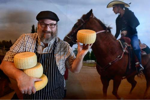 Scott Sommerdorf   |  The Salt Lake Tribune
Kendall S. Russell of Lark's Meadow Farms in Rexburg, Idaho, poses with some of his cheeses at the Natural History Museum of Utah's Chocolate & Cheese Festival, Sunday, March 29, 2015. He is holding the "Helen" cheese, lower left, and three rounds of "Dulcinea" cheese in front of the museum's horse and rider image.
