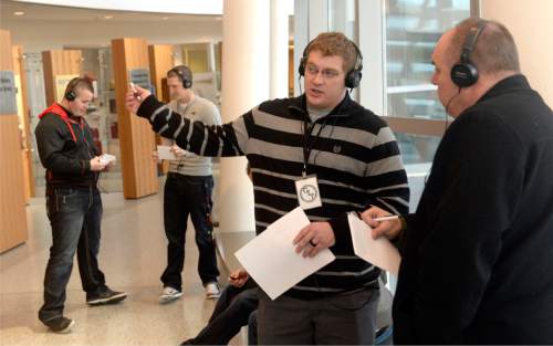 Al Hartmann  |  The Salt Lake Tribune
Salt Lake Police  recruit Jake Daley, left, is interviewed as a "witness" by Murray police officer Troy Peterson in a mock bank robbery scenario. They both wear headphones with distracting background voices playing to simulate what a mentally ill person might hear. They have to work through the noise and concentrate on asking the right questions and remembering details of the robbery.  It was a part of CIT (crisis intervention training) for police, which shows them how to de-escalate encounters with the mentally ill at the Salt Lake City Public Safety Building Wednesday Jan 15.