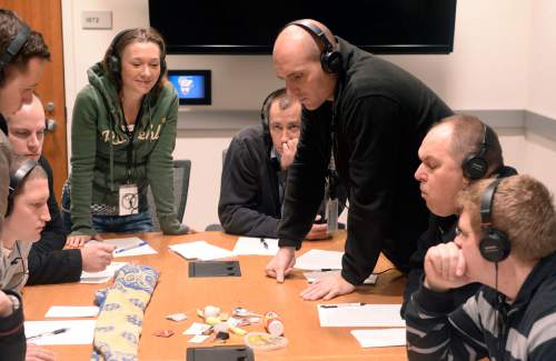 Al Hartmann  |  The Salt Lake Tribune
Police officers and recruits wear headphones with distracting background voices playing to simulate what a mentally ill person might hear in everyday life.  With the noise playing they concentrate on memorizing details of a dozen everyday items and later writing down the items and details.  It was a part of CIT (crisis intervention training) for police, which shows them how to de-escalate encounters with the mentally ill at the Salt Lake City Public Safety Building Wednesday Jan 15.