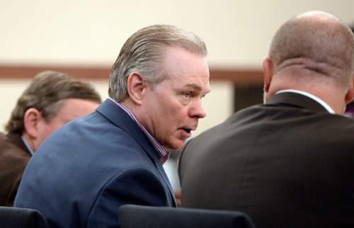 Al Hartmann  |  The Salt Lake Tribune 
Douglas Anderson Lovell, 57, convicted of aggravated murder for kidnapping and killing 39-year-old Joyce Yost in 1985 to keep her from testifying against him in a rape case, talks to his defense lawyers in Ogden Tuesday March 31, 2015, for the last day of his death penalty trial. The prosecution and defense gave their closing arguments Tuesday.