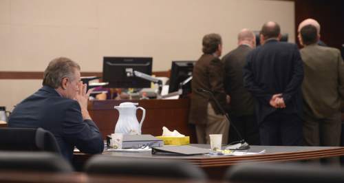Al Hartmann  |  The Salt Lake Tribune 
Douglas Anderson Lovell sits by himself at the defense table as Judge Michael D. DiReda calls lawyers to his bench during closing arguments in Ogden Tuesday March 31, 2015. Prosecutors asked for the death penalty for Lovell. Lovell, 57, has been convicted of aggravated murder for kidnapping and killing 39-year-old Joyce Yost in 1985 to keep her from testifying against him in a rape case.