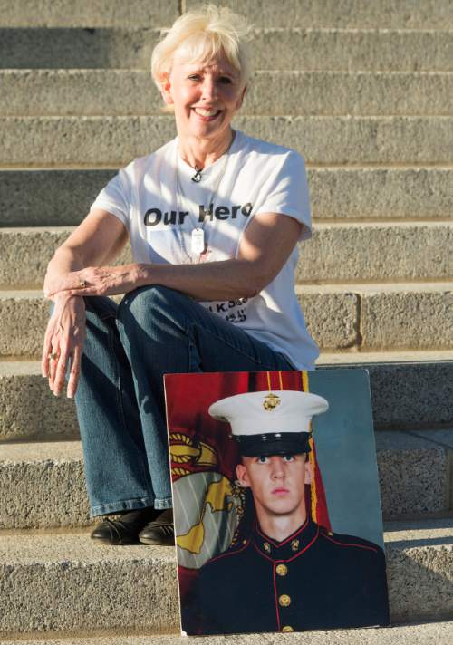 Rick Egan  |  The Salt Lake Tribune

Kim Olsen, with a photo of her son, Nigel K. Olsen, that was killed March 4, 2010, joined a rally with a group of veterans to urge Gov. Herbert to veto HB385, which would name a portion of I-15--known as the Veterans Memorial Highway -- after former Speaker Becky Lockhart, at the Utah State Capitol, Monday, March 30, 2015