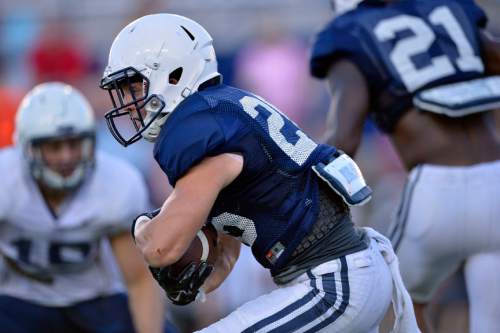 Chris Detrick  |  The Salt Lake Tribune
Brigham Young Cougars Nate Carter (26) runs the ball during a scrimmage at LaVell Edwards Stadium Friday August 15, 2014.