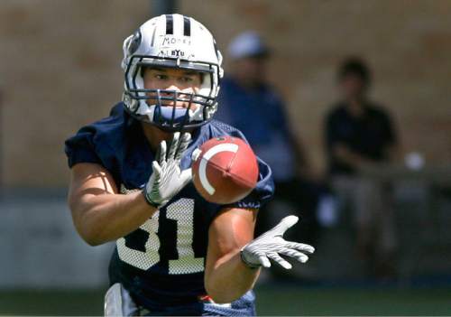 Scott Sommerdorf  l  Tribune file photo
BYU RB AJ Moore catches a pass during practice at BYU on Monday, August 9, 2010.