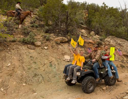 Trent Nelson  |  The Salt Lake Tribune
Under the eyes of a mounted Kane County Sheriff's Deputy, motorized vehicles make their way through Recapture Canyon, which has been closed to motorized use since 2007, after a call to action by San Juan County Commissioner Phil Lyman. Saturday May 10, 2014 north of Blanding.