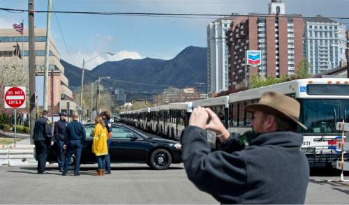 Lennie Mahler  |  The Salt Lake Tribune

A man stops to take a photograph in front of a barricade of buses on 500 South that blocks off traffic for cars entering the Sheraton hotel in Salt Lake City, Thursday, April 2, 2015. President Barack Obama is expected to stay at the hotel before speaking at Hill Air Force Base on Friday.