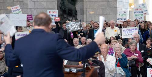 Al Hartmann  |  The Salt Lake Tribune 
Sen. Jim Debakis, D Salt Lake in foreground stirs the crowd up at The Utah Health Policy Project, as hundreds of citizens and advocates of the governor's plan to expand Medicaid, Healthy Utah rally at noon Thursday March 5 inside the capitol rotunda.