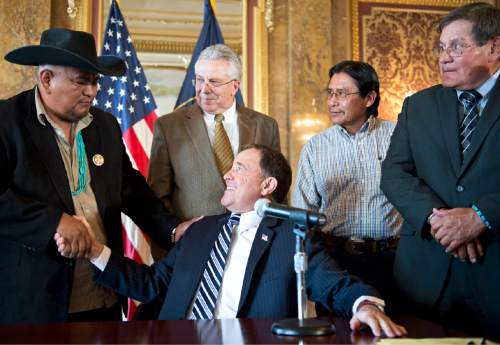 Lennie Mahler  |  The Salt Lake Tribune

Gov. Gary Herbert shakes hands with Davis Filfred, Navajo Nation Council delegate from Utah, after signing SB90, Utah Navajos Royalties bill, in the Gold Room at the Utah State Capitol on Monday, March 30, 2015. Also pictured are Rep. Jack Draxler, House sponsor of the bill, Navajo community member Harrison Johnson and Navajo Nation Council Speaker LoRenzo Bates.