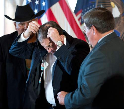 Lennie Mahler  |  The Salt Lake Tribune

David Filfred and LoRenzo Bates from the Navajo Nation Council present Gov. Gary Herbert with a bolo tie following the signing of three bills involving the Navajo community at the Utah State Capitol, Monday, March 30, 2015.
