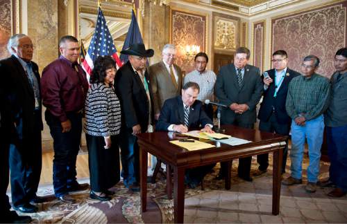 Lennie Mahler  |  The Salt Lake Tribune

Gov. Gary Herbert signs SB90, Utah Navajos Royalties bill, in the Gold Room at the Utah State Capitol on Monday, March 30, 2015. Behind him are legislators and members of the Utah Navajo community.