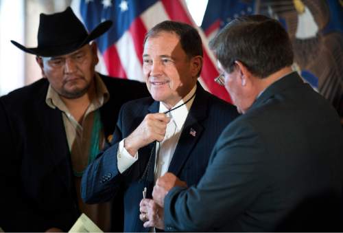 Lennie Mahler  |  The Salt Lake Tribune

Davis Filfred and LoRenzo Bates from the Navajo Nation Council present Gov. Gary Herbert with a bolo tie following the signing of three bills involving the Navajo community at the Utah State Capitol, Monday, March 30, 2015.