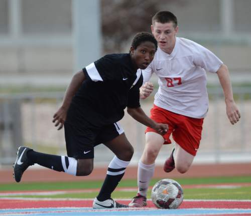 Steve Griffin  |  The Salt Lake Tribune

Cottonwood's Dejen Abreha cuts in from of Granger's Brendon Mortensen during the Cottonwood versus Granger boy's soccer game at Granger High School in West Valley City, Tuesday, March 31, 2015.
