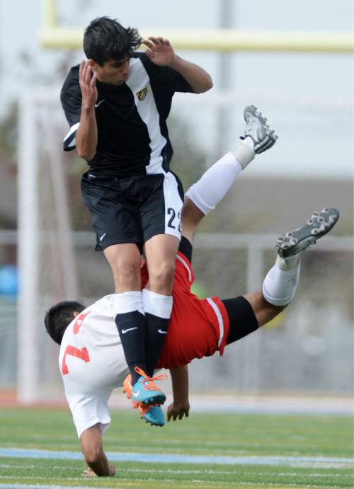 Steve Griffin  |  The Salt Lake Tribune

Granger's Hector Landeros, back, falls to the ground after performing a bicycle kick in from of Cottonwood's Matthew Orme during the Cottonwood versus Granger boy's soccer game at Granger High School in West Valley City, Tuesday, March 31, 2015.