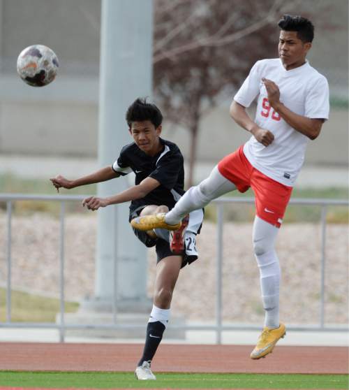 Steve Griffin  |  The Salt Lake Tribune

Cottonwood's Frank DeBry centers the ball as Granger's Brandon Blanco tries to block it during the Cottonwood versus Granger boy's soccer game at Granger High School in West Valley City, Tuesday, March 31, 2015.