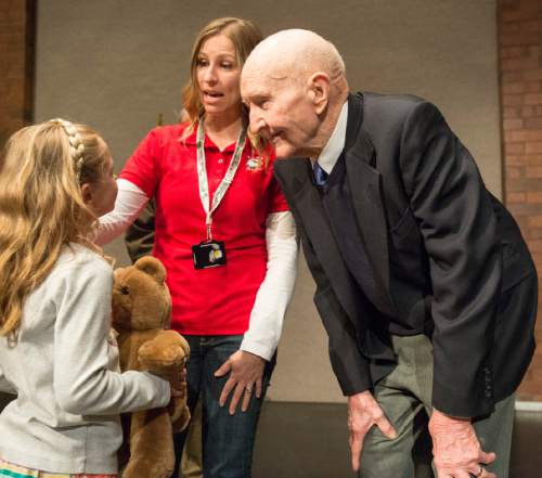 Rick Egan  |  The Salt Lake Tribune

Gail Halvorsen, 94 years old and known around the world as the Berlin Candy Bomber, shares his teddy bear story with 8-year-old Avery Navratil, before speaking at Oquirrh Hills Middle School, Wednesday, April 1, 2015.  Avery's mother, Kimberly Navratil is in the red shirt.