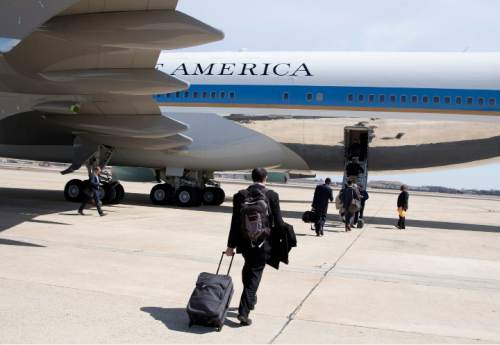 Thomas Burr with the The Salt Lake Tribune, boards Air Force One, Thursday, April 2, 2015, in Andrews Air Force Base, Md., en route to Louisville, Ky., where he will report on President Barack Obama as he tours and speak at Indatus, a Louisville-based technology company that specializes in cloud-based products and services. The president will discuss his concerns about $300 billion cost of eliminating a tax that the White House says would affect relatively few people. (AP Photo/Carolyn Kaster)