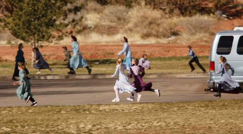 Trent Nelson  |  The Salt Lake Tribune
Young girls and boys make a game out of running while on a school recess in Hildale, 2006.
