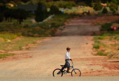 Trent Nelson  |  The Salt Lake Tribune
A young boy rides his bike in Colorado City, Arizona in 2005.