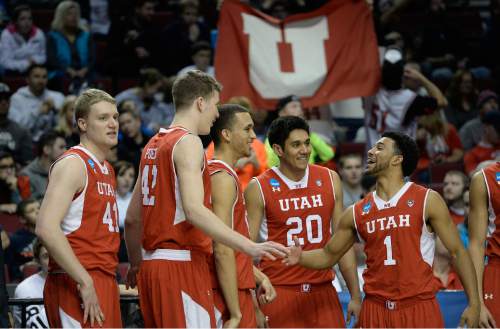 Scott Sommerdorf   |  The Salt Lake Tribune
Utah Utes guard Isaiah Wright (1), right, celebrates with Utah Utes forward Jakob Poeltl (42) and other team mates as Utah stretched it's lead to ten points late in the game. Utah defeated Georgetown 75-64 to advance to the "Sweet Sixteen", Saturday, March 21, 2015.