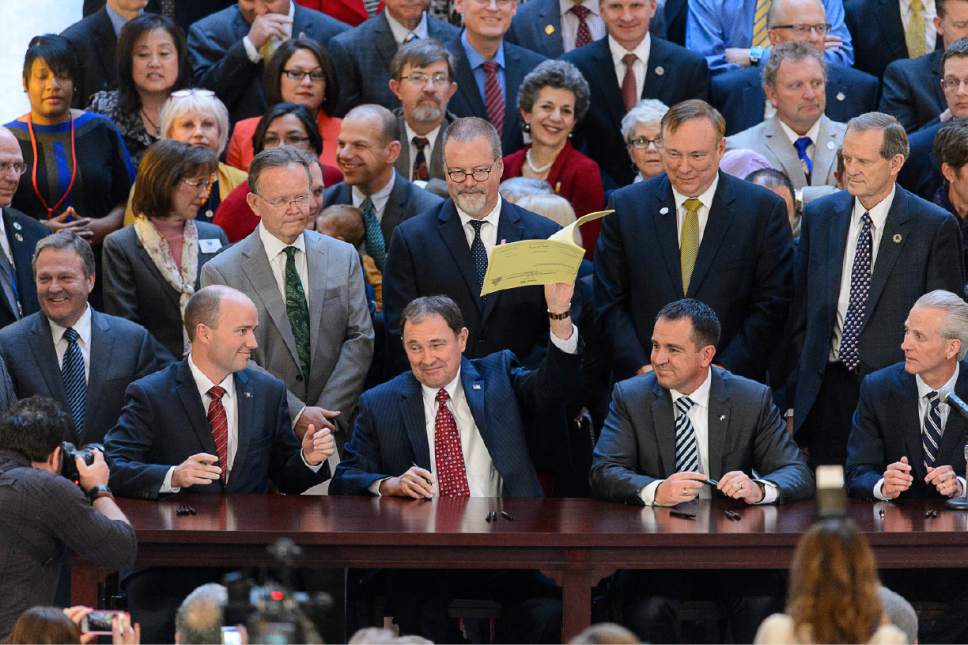 Trent Nelson  |  The Salt Lake Tribune
Gov. Gary Herbert signs into law SB296 on Thursday, which gives statewide non-discrimination protections to the gay and transgender community, while providing safeguards for religious liberty, in the rotunda of the State Capitol Building in Salt Lake City.