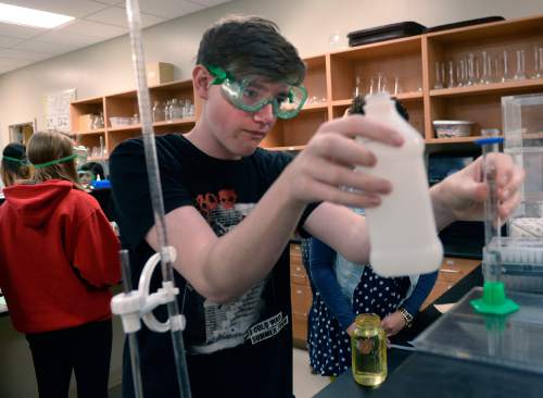 Al Hartmann  |  The Salt Lake Tribune 
Salt Lake Center for Science Education tenth-grader Elliot Hamilton takes measurement during an experiment in making biodiesel from used cooking oils from local restaurants Tuesday April 7, 2015. The state school board will vote this week on advancing new science standards that emphasize engineering and hands-on experimentation.