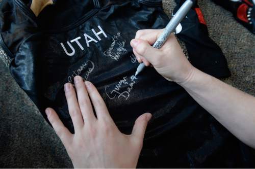 Scott Sommerdorf   |  The Salt Lake Tribune
Utah senior gymnast Georgia Dabritz autographs a leotard, Thursday, April 9, 2015. Dabritz is winding up her stellar career next week as one of the University of Utah greats.