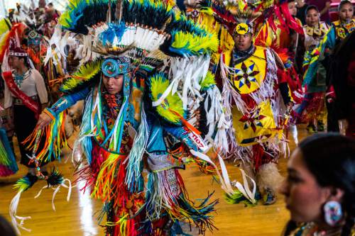 Chris Detrick  |  The Salt Lake Tribune
Participants enter during the ceremonial Grand Entry during the 43rd annual Sustaining our Culture Powwow presented by University of Utahís Inter-Tribal Student Association at the University of Utah Union Ballroom Saturday April 11, 2015.