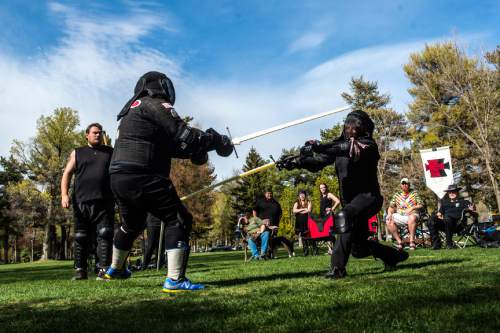 Chris Detrick  |  The Salt Lake Tribune
Jordan Hinckley, left, and Dave Maxfield compete at Liberty Park Saturday April 11, 2015. The United Clans Swordsman Association and the True Edge Academy of Swordsmanship competed in their first-ever sword competition between the two groups. Both organizations are members of the national nonprofit Historical European Martial Arts Alliance. Techniques taught include Long sword, Short Sword and buckler, Dagger, Pole hammer and unarmed fighting and defense.