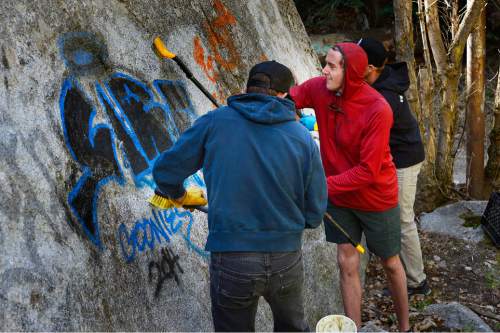 Scott Sommerdorf   |  The Salt Lake Tribune
Volunteer Hayden Jamison, right, scrubs a graffito with Elephant Snot solvent during the ROCK Project cleanup effort in Little Cottonwood Canyon, Sunday, April 12, 2015.