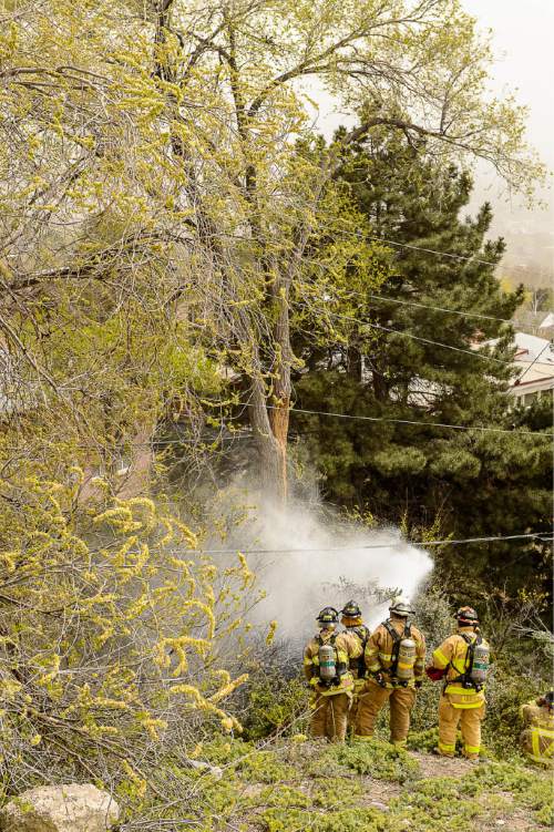 Trent Nelson  |  The Salt Lake Tribune
Salt Lake City firefighters beat down a fire above 13th Avenue and I Street in Salt Lake City, Tuesday April 14, 2015.