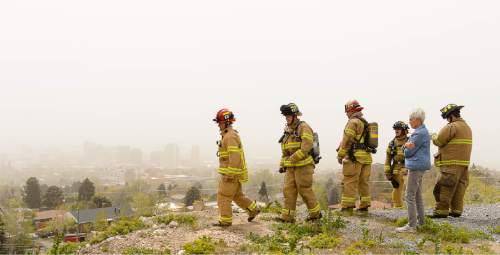 Trent Nelson  |  The Salt Lake Tribune
Salt Lake City firefighters look down on a fire above 13th Avenue and I Street in Salt Lake City, Tuesday April 14, 2015.