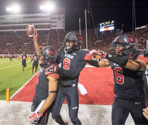 Rick Egan  |  The Salt Lake Tribune
 
Utah Utes wide receiver Kaelin Clay (8) celebrates with wide receiver Tim Patrick (9) and Utah Utes wide receiver Dres Anderson (6) after scoring the game-winning touchdown, with 8 seconds left in the game, giving the Utes a 24-21 victory of the USC Trojans in Pac-12 action at Rice-Eccles Stadium, Saturday, October 25, 2014.