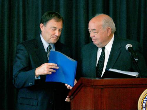 Scott Sommerdorf  l  The Salt Lake Tribune
Former Utah Governor Norm Bangerter (right) hands the Commision's report to Utah Governor Gary Herbert. The Commission to Optimize State Government members presented Utah Gov. Gary Herbert with its report – the result of a nearly yearlong effort to identify areas for increased efficiency within state government in Salt Lake City on Thursday, August 19, 2010.
