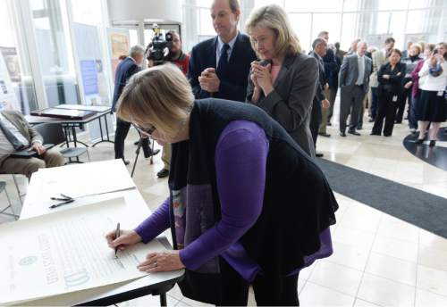 Francisco Kjolseth  |  The Salt Lake Tribune 
Utah Supreme Court Justices, Christine M. Durham, Jill N. Parrish and Associate Chief Justice Thomas R. Lee, from bottom, sign the Magna Carta Parchment as the Utah State Courts holds a ceremony at the Matheson Courthouse to recognize the 800-year anniversary of the signing of the Magna Carta. A traveling exhibit of the Magna Carta, organized by the Utah State Bar, will be on display from April 15 through 17 in the Matheson Courthouse rotunda.