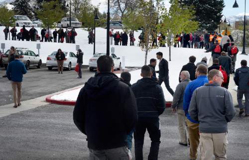 Scott Sommerdorf   |  The Salt Lake Tribune
Workers head to their evacuation points in the east parking lots as they evacuate the State Office Building during the annual Great Utah ShakeOut earthquake drill at the Utah State Capitol complex, Thursday, April 16, 2015.