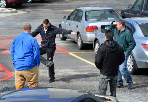 Scott Sommerdorf   |  The Salt Lake Tribune
As they wait for the "All-Clear" to be sounded, workers pass the time in the east parking lots by playing hacky sack after they evacuated the State Office Building during the annual Great Utah ShakeOut earthquake drill at the Utah State Capitol complex, Thursday, April 16, 2015.