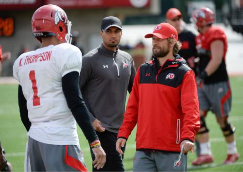 Francisco Kjolseth  |  The Salt Lake Tribune 
Aaron Roderick, right, works with players as the University of Utah football team practices at Rice Eccles stadium on Thursday, April 16, 2015.