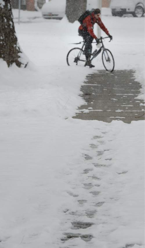 Francisco Kjolseth  |  The Salt Lake Tribune 
University of Utah students navigate the snow as a powerful storm blankets the valley in snow, covering any signs of early spring on Wednesday, April 15, 2015.
