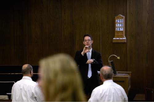 Scott Sommerdorf   |  The Salt Lake Tribune
First Counselor Ben Edwards speaks prior to services at the Salt Lake Valley 1st Ward. The ward caters to hearing-impaired and visually impaired Mormons and conducts services in American Sign Language, Sunday, March 29, 2015.