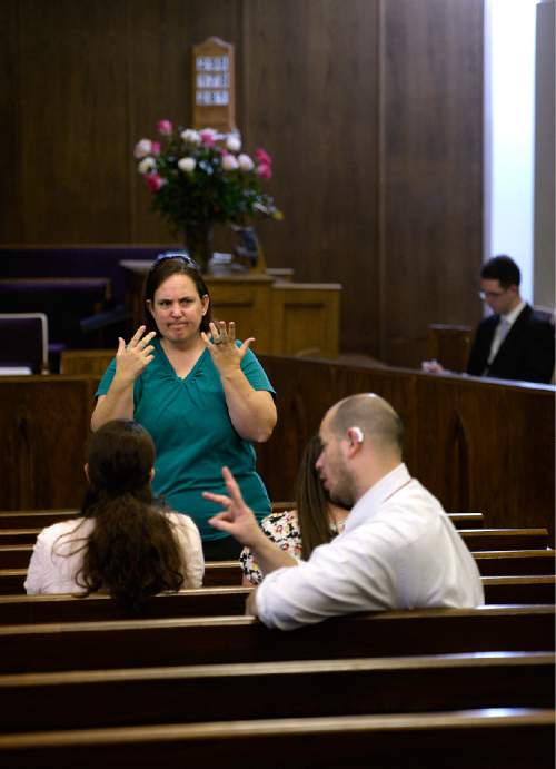 Scott Sommerdorf   |  The Salt Lake Tribune
Congregants speak to each other in silence prior to services at the Salt Lake Valley 1st Ward. The ward caters to hearing-impaired and visually impaired Mormons and conducts services in American Sign Language, Sunday, March 29, 2015.