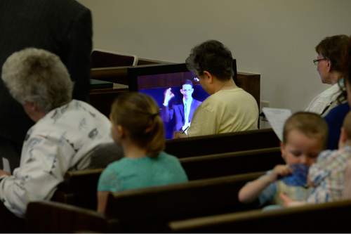 Scott Sommerdorf   |  The Salt Lake Tribune
Congregants watch First Counselor Ben Edwards speak on monitors during services at the Salt Lake Valley 1st Ward. The ward caters to hearing-impaired and visually impaired Mormons and conducts services in American Sign Language, Sunday, March 29, 2015.
