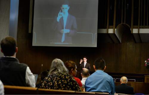 Scott Sommerdorf   |  The Salt Lake Tribune
Congregants watch First Counselor Ben Edwards speak via a projected video image during services at the Salt Lake Valley 1st Ward. The ward caters to hearing-impaired and visually impaired Mormons and conducts services in American Sign Language, Sunday, March 29, 2015.